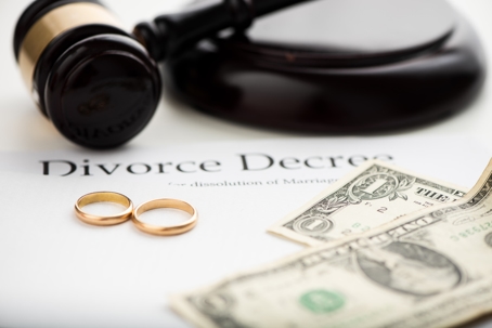 gavel, wedding rings, money, and divorce decree
